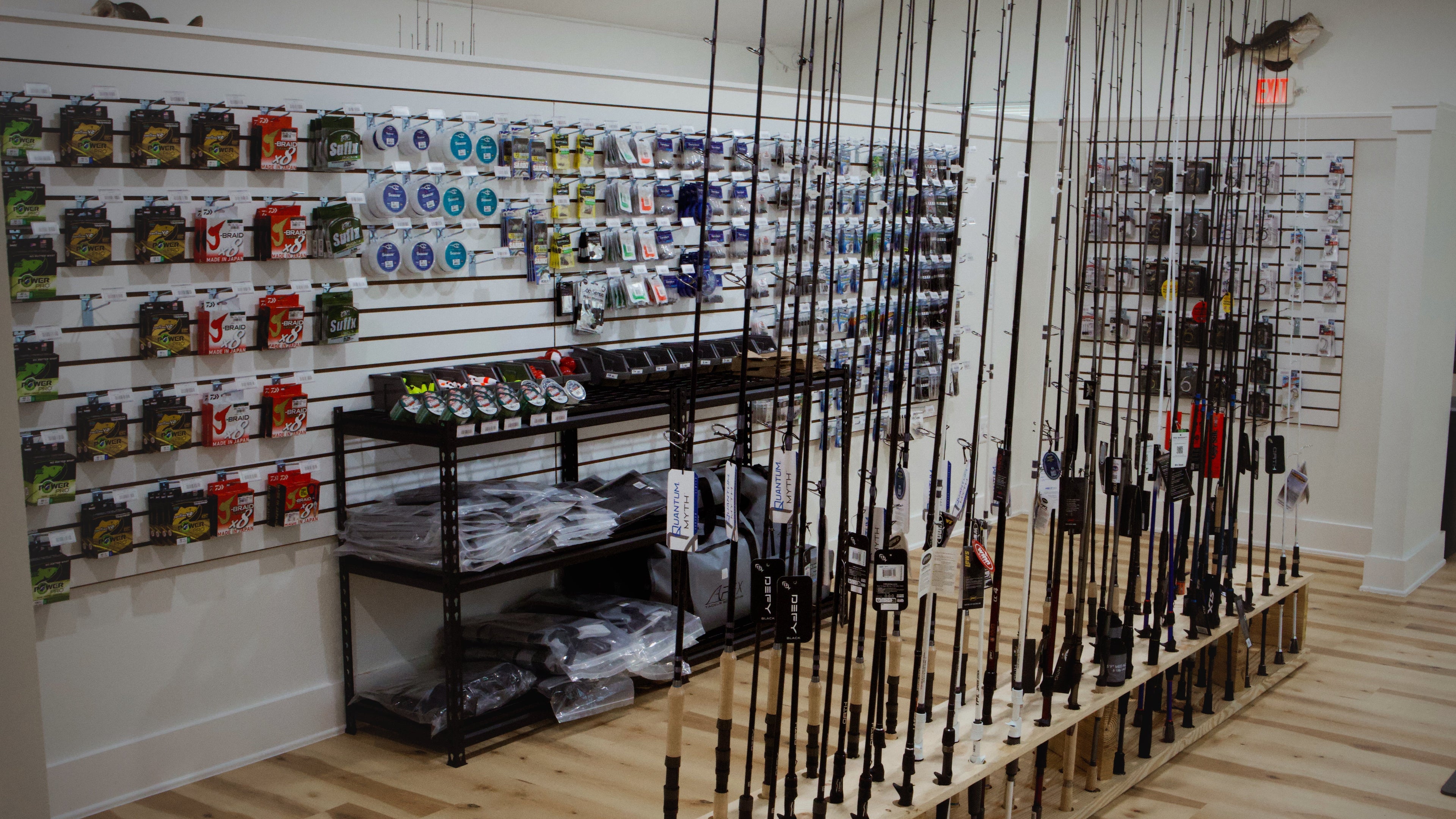 Fishing store interior with fishing rods displayed on a rack.
